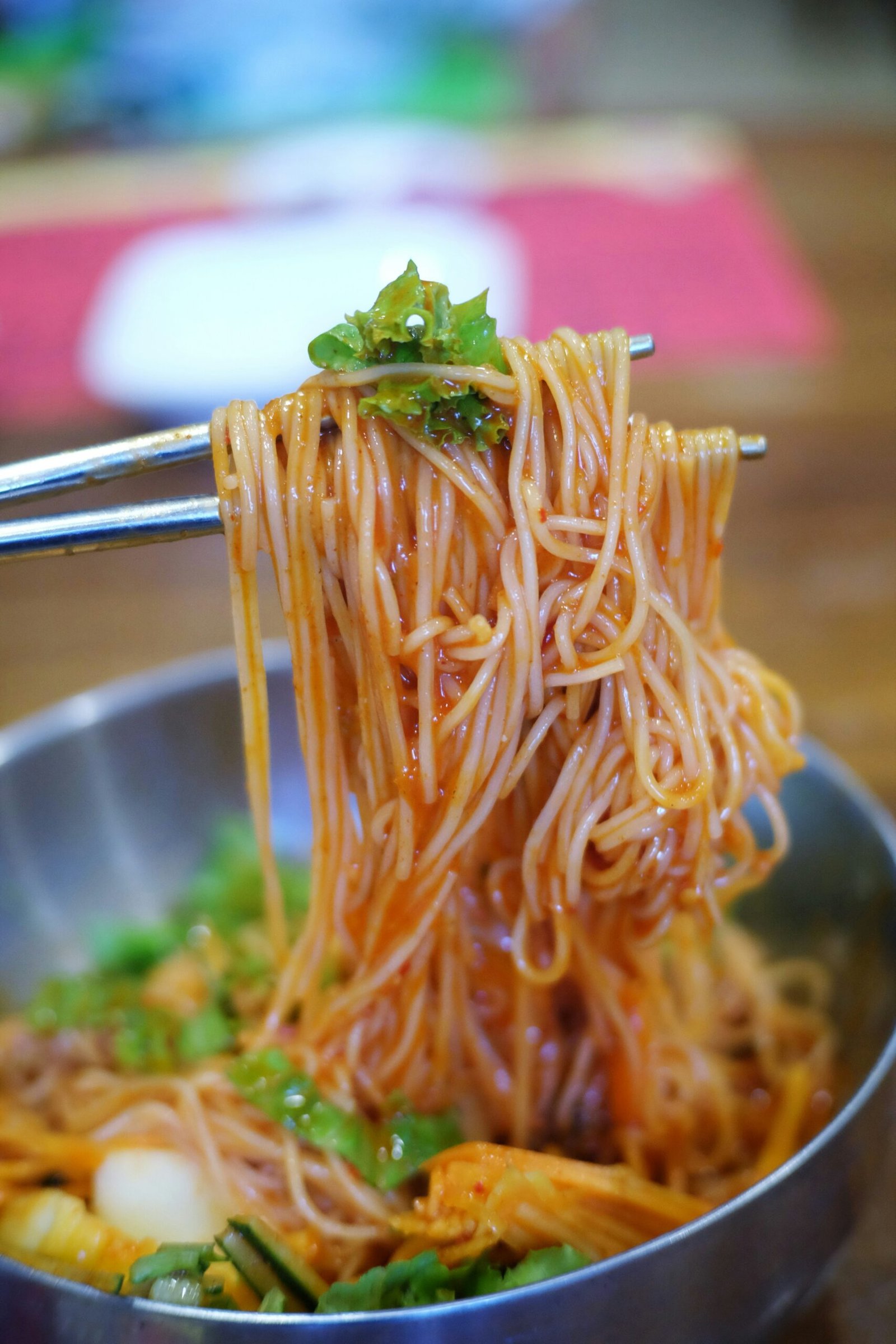 pasta with green leaf on stainless steel bowl